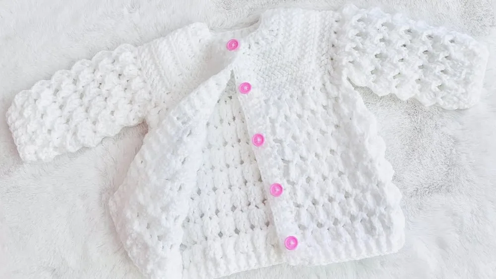Marshmallow stitch baby cardigan with a fan-stitch hem